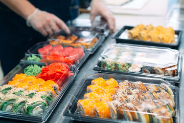 Sushi delivery. Many varieties of Sushi in a plastic box are prepared for delivery.