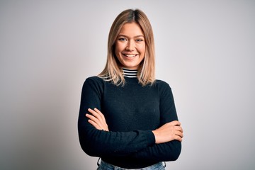 Young beautiful blonde woman with blue eyes standing over white isolated background happy face...
