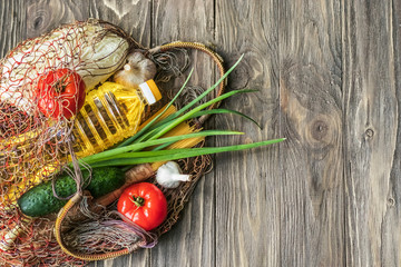 No concept of a plastic bag. Net bags for healthy food vegetables. Fresh fruits and vegetables, pasta on a wooden background. Top view, copy space. Flat lay