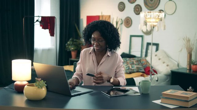 African-American lady is using a laptop for shopping in self-isolation