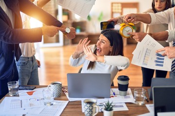 Group of business workers working together. Partners stressing one of them at the office