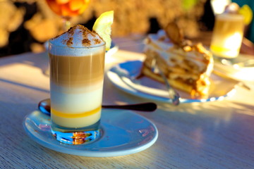 Zaperoco caffee and cake on the table in golden sun. Tenerife,  Puerto de la Cruz, Tarao Garden.