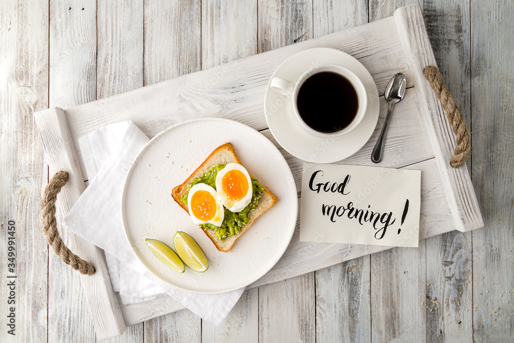 Wall mural Toast with guacamole and boiled egg, avocado toast with coffee cup - Wall murals