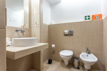 Fototapeta na wymiar Modern bathroom with bathtub, mirror and washbasin. European hotel design.