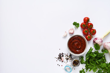 Tomato sauce with spices and scabies on a white plate. Layout