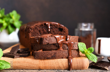 Brownie is a classic American dessert. Chocolate muffin with chocolate sauce and mint.