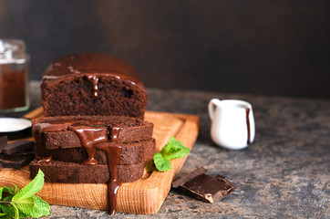 Brownie is a classic American dessert. Chocolate muffin with chocolate sauce and mint.
