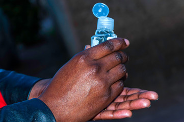 Applying hand sanitizer to prevent corona-virus and other infectious bacteria.