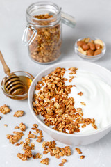 Granola and greek yogurt breakfast with honey and nuts