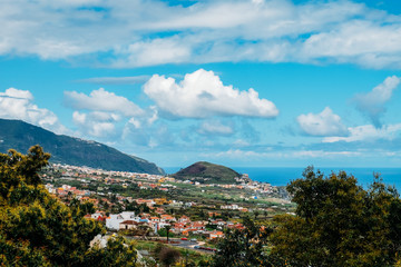 Tropical island of Tenerife. The coast of a Spanish city on the Atlantic ocean. Panorama of the city and beach on the island of Tenerife. Background color with gradient and grain, sound effect.