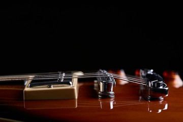 high contrast close up view for electric guitar. side view. music still life concept. bottom border.