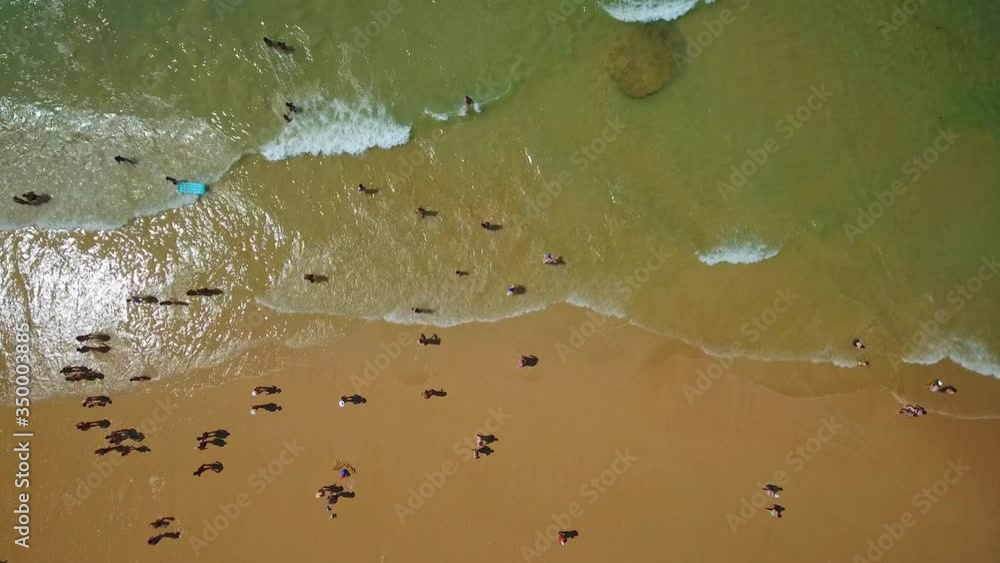 Sticker Aerial photo of the coast, the beaches of Gale in Portugal. Tourists rest in the sand and swim in the clear water.