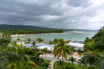 wide angle shot of a beautiful tropical resort beach scene on a gray cloudy day