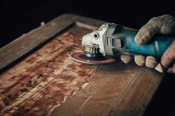 grinding with an electric wood grinder, restoration of solid wood furniture. Woodwork