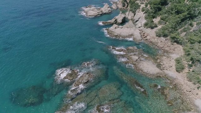 AERIAL DRON CLOSE 45 DEGREE ROCKY COAST REVEAL AND TURQUOISE WATER, MEDITERRANEAN SEA