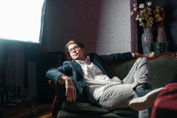 close-up portrait of an attractive young man relaxing on the couch