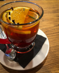 hot tea served in glass cup with orange
