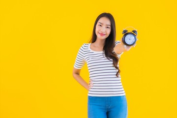 Portrait beautiful young asian woman show clock or alarm