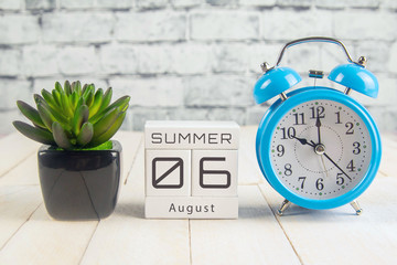 August 6 on the wooden calendar.The sixth day of the summer month, a calendar for the workplace....