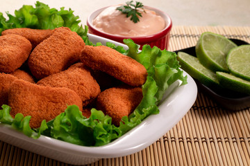 Breaded chicken with rose and lemon sauce