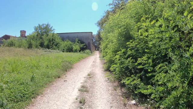 a gravel road next to Abbey of St Peter at Badia Pozzeveri village, municipality of Altopascio, province of Lucca, Tuscany, Italy  