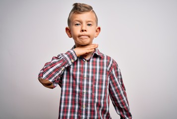 Young little caucasian kid with blue eyes wearing elegant shirt standing over isolated background cutting throat with hand as knife, threaten aggression with furious violence