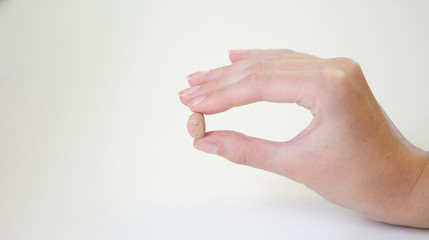 Very small hearing aid in a female hand