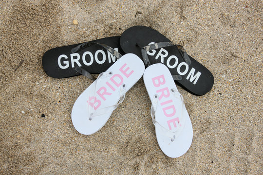  Bride and groom flip flops on the beach