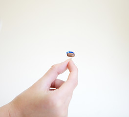 Very small hearing aid in a female hand