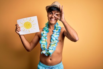 Tourist man on vacation wearing swimwear and hawaiian lei flowers holding banner with sun with...