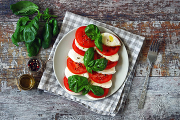 Traditional caprese salad with tomato mozzarella and basil. Healthy salad. Diet food.