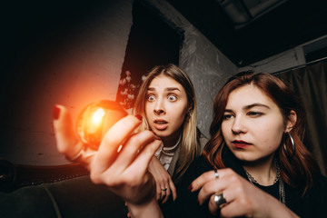 Woman and woman fortune teller with crystal ball