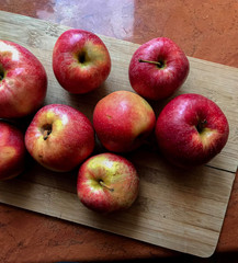 fresh red apples on wooden desk