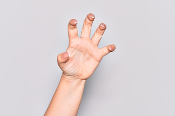 Hand of caucasian young woman grasping aggressive and scary with fingers, violence and frustration
