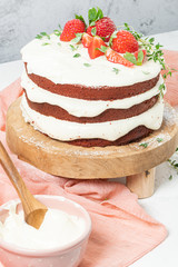 Red velvet cake on wood board. Strawberry cake. Devils cake. Wedding dessert. Birthday party. Delicious dessert. Traditional american dessert.