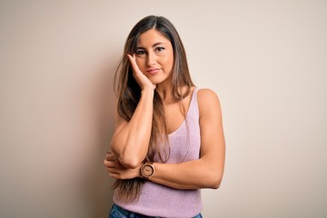 Young beautiful brunette woman with long hair standing over isolated background thinking looking tired and bored with depression problems with crossed arms.