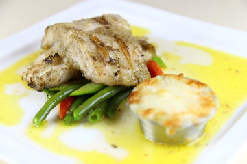 Steamed Fish Steak with Mash Potatoes and Vegies on a ceramic plate