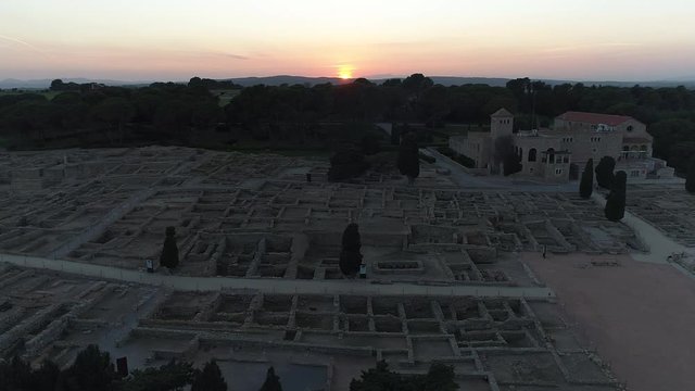 AERIAL DRONE SIDE VIEW AND FINAL ORBIT OF SUNSET IN ROMAN RUINES, EMPURIES, CATALONIA, SPAIN