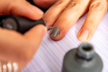 Fototapeta premium manicure with his hands working with cleaning elements and enamels
