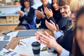 Group of business workers smiling happy and confident. Working together with smile on face looking at the camera applauding at the office