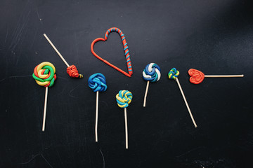 candy made of plasticine on a dark background