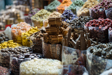 Colourful Spices with Cinnamon Pile at Souk Market Medina in Dubai, United Arab Emirates