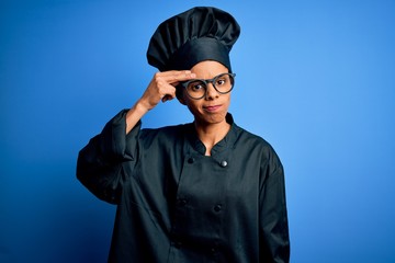 Young african american chef woman wearing cooker uniform and hat over blue background worried and stressed about a problem with hand on forehead, nervous and anxious for crisis