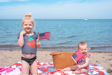 Two little girls having a picnic at the beach