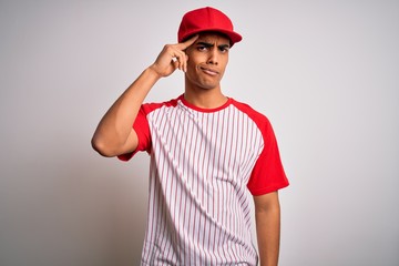 Young handsome african american sportsman wearing striped baseball t-shirt and cap worried and stressed about a problem with hand on forehead, nervous and anxious for crisis