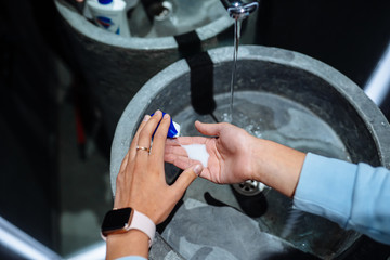 Woman washing hands to protect against the coronavirus