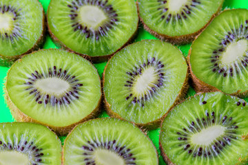 kiwi slices on a green background