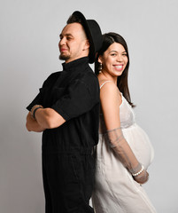 Portrait of young happy smiling beautiful couple in love standing together and holding glass of milk