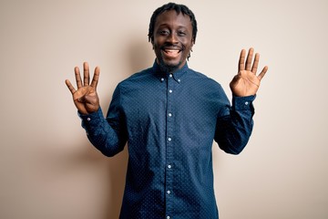 Young handsome african american man wearing casual shirt standing over white background showing and...