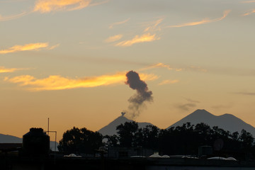 sunset over the city and a volcano